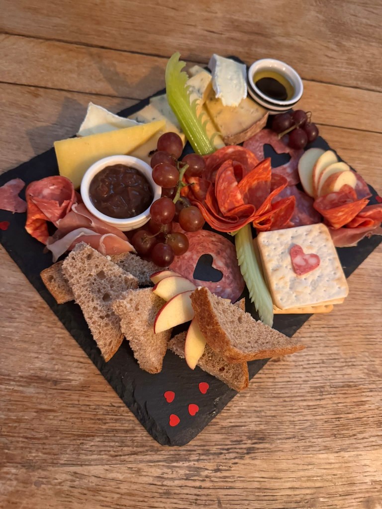Charcuterie and cheese sharing platter on a slate board